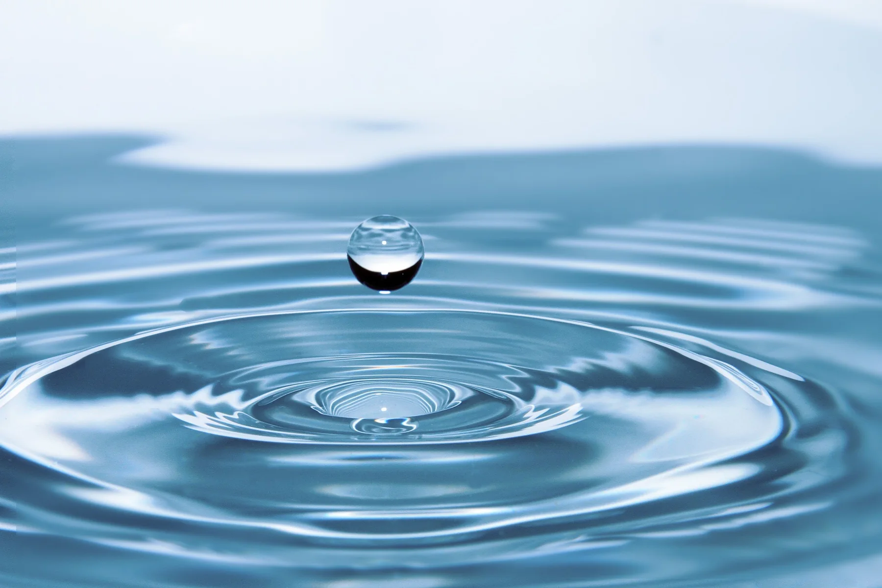A water droplet creating circular ripples
